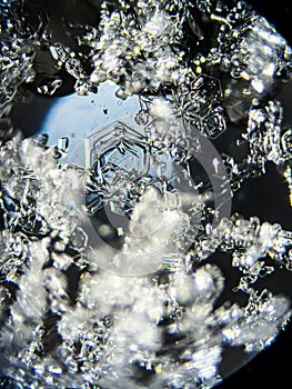 View on snowflake under microscope ocular