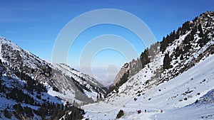 View from the snowy gorge in the mountains to the clouds and the city smog.