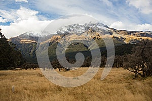 View on a snowy mountain range in clouds over place where Isengard was filmed in LOTR trilogy, Fangorn on the left, Rees Dart