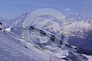 View of the snowy mountain peaks around Pila in Aosta Valley Italy photo