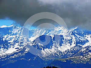 View of the snowy peaks and glaciers of the Swiss Alps from the Pilatus mountain range in the Emmental Alps, Alpnach - Switzerland