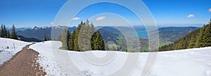 View from snowy wallberg mountain to green valley and lake tegernsee