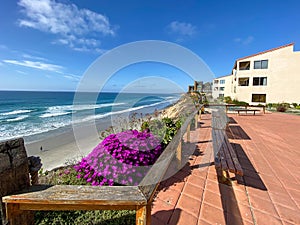 A view of Solana Beach from the top of the cliff with wood bench