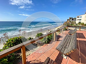 A view of Solana Beach from the top of the cliff with wood bench