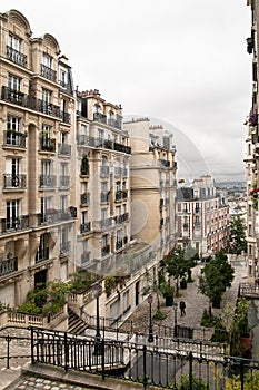 A view of some historical buildings and a little view of Paris, through the buildings in Monmarte photo