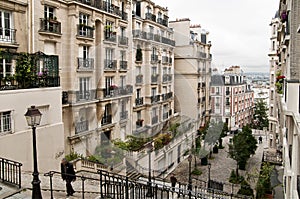 A view of some historical buildings and a little view of Paris, through the buildings in Monmarte photo