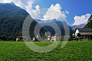 View on Sonogno over green meadow