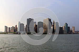 View of the southern tip of Manhattan from New York Harbor at sunset photo