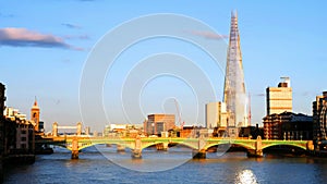 View of Southwark Bridge in the evening with other landmarks in London, England, UK