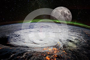 View from space of a giant hurricane over the ocean with full moon rise in background