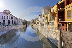 View of the Spanish city of Orihuela on the banks of the Segura river with colorful houses