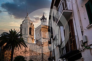 View of spanish town of Sitges landmark building of the Ajuntament, known as Casa de la Vila, at sunset with dramatic light