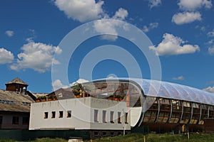 View of a special oval building with an outbuilding on the roof of the annex