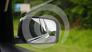 view of speedway in rear car reflection