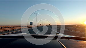 view of the speedway road from the car at the sunset