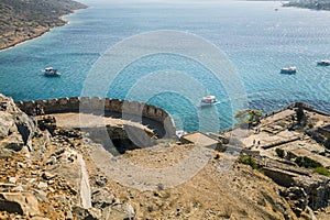 View from the Spinalonga fortress on the island. Boat trips to the island of lepers. Ships on the sea at the edge of the island