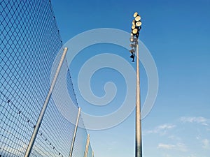 View of a spotlight with background of blue skies and safety net