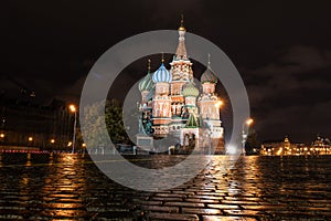 View of St Basil`s cathedral at night with paving stone of red square