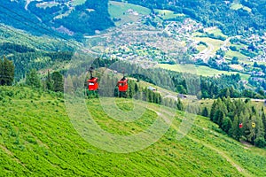 View of St.Gilgen and red Seilbahn cable car gondolas from Zwolferhorn mountain