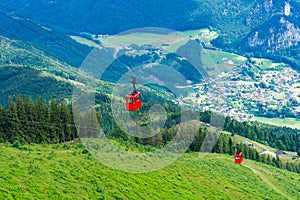 View of St.Gilgen and red Seilbahn cable car gondolas from Zwolferhorn mountain