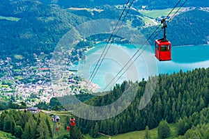 View of St.Gilgen and red Seilbahn cable car gondolas from Zwolferhorn mountain