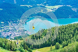 View of St.Gilgen, Wolfgangsee lake, mountains and colorful Seilbahn cable car gondolas from Zwolferhorn mountain