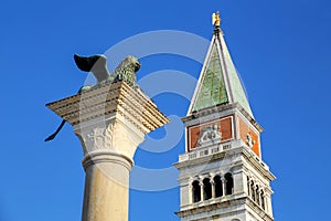 View of St Mark`s Campanile and Lion of Venice statue at Piazzetta San Marco in Venice, Italy