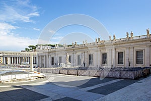 View of St. Peter`s Square with semicircular colonnade with statues Piazza Obliqua and St. Peter`s Basilica in Vatican City