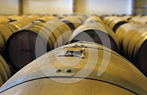 View of stacked casks at a whisky distillery in a row under the light