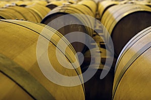 View of stacked casks at a whisky distillery in a row under the light