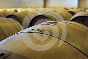 View of stacked casks at a whisky distillery in a row under the light