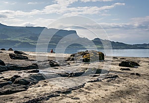 A view of Staffin island and Staffin harbour. Garrafad bay and An Corran Beach. People on the beach searching for dinosaur