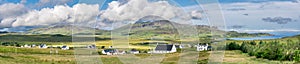 A view of Staffin village on the Isle of Skye with Quiraing Hills in the background