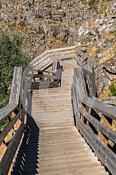 View of a stairs on wooden suspended pedestrian walkway on mountains, overlooking the Paiva river