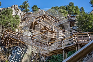 View of a stairs on wooden suspended pedestrian walkway on mountains, overlooking the Paiva river photo