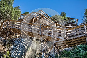 View of a stairs on wooden suspended pedestrian walkway on mountains, overlooking the Paiva river photo