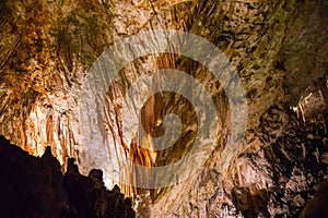 View of stalactites and stalagmites in an underground cavern - Postojna cave, Slovenia