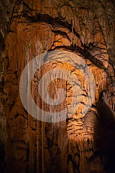 View of stalactites and stalagmites in an underground cavern - Postojna cave, Slovenia