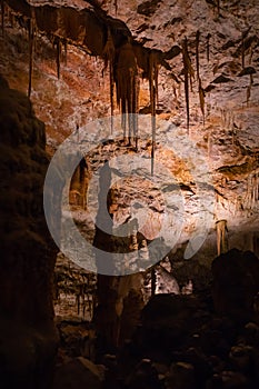 View of stalactites and stalagmites in an underground cavern - Postojna cave, Slovenia