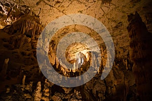 View of stalactites and stalagmites in an underground cavern - Postojna cave, Slovenia