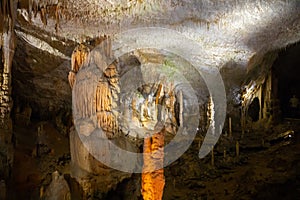 View of stalactites and stalagmites in an underground cavern - Postojna cave, Slovenia