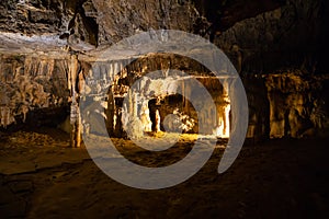 View of stalactites and stalagmites in an underground cavern - Postojna cave, Slovenia