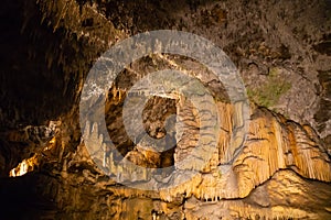 View of stalactites and stalagmites in an underground cavern - Postojna cave, Slovenia