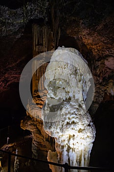 View of stalactites and stalagmites in an underground cavern - Postojna cave, Slovenia