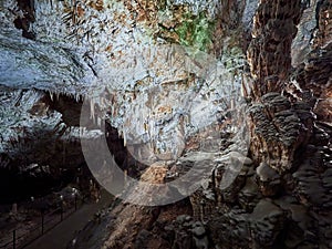 View of stalactites and stalagmites in an underground cavern - Postojna cave in Slovenia