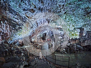 View of stalactites and stalagmites in an underground cavern - Postojna cave in Slovenia