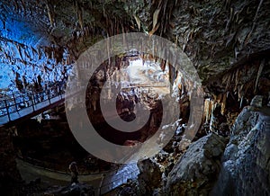 View of stalactites and stalagmites in an underground cavern - Postojna cave in Slovenia