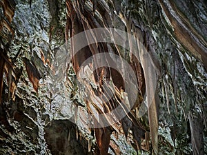 View of stalactites and stalagmites in an underground cavern - Postojna cave in Slovenia