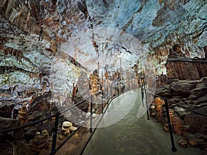 View of stalactites and stalagmites in an underground cavern - Postojna cave in Slovenia