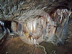 View of stalactites and stalagmites in an underground cavern - Postojna cave in Slovenia